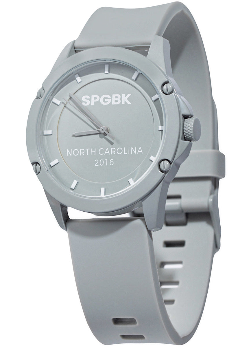 A cool gray analog watch with a silicone strap and a round stainless steel case, featuring a three-hand quartz movement.