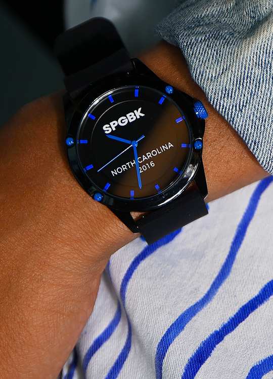 Black watch with blue accents on a wrist, featuring 'SPGBK' and 'North Carolina 2016' text.
