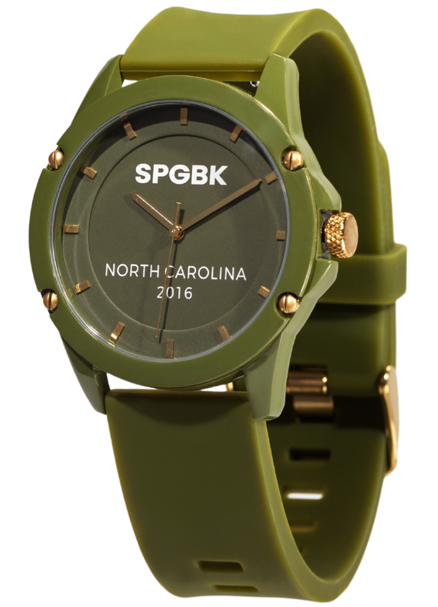 Green watch with gold accents on a white background